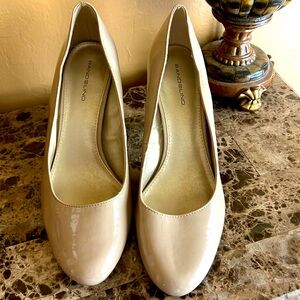 Bandolino Nude colored patent leather pumps.